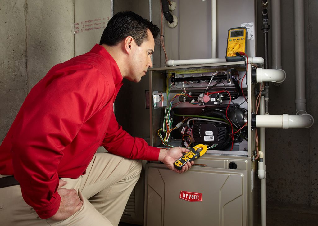HVAC technician repairing an indoor furnace in Louisville