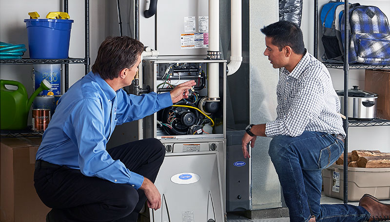 HVAC technician evaluating a furnace for repair or replacement in Louisville