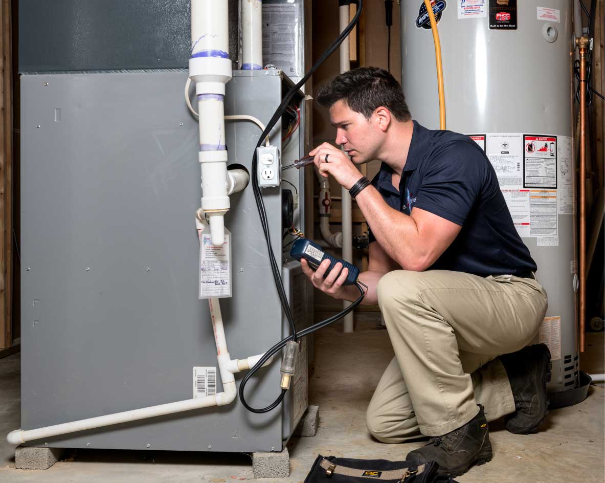 HVAC technician performing a furnace tune-up in Louisville