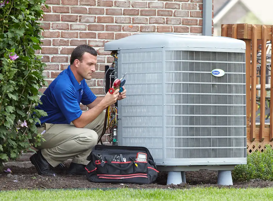 HVAC technician inspecting an outdoor air conditioning unit in Louisville