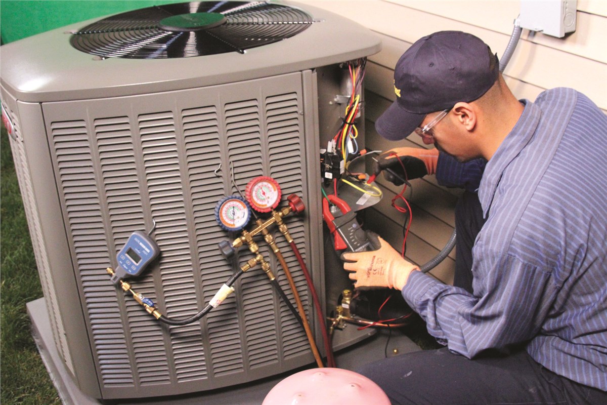 HVAC technician testing an outdoor air conditioning unit in Louisville